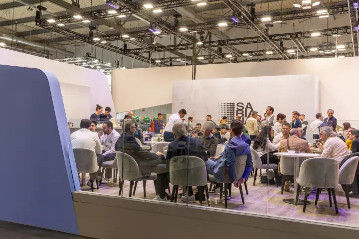 Busy Sabiana hospitality area with visitors at round tables at MCE 2026