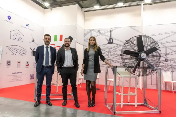CGM Impianti team beside a large circulation fan on an aluminium frame