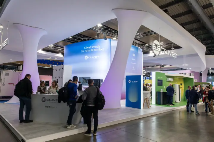 Clivet stand reception counter under flowing white columns at MCE 2026