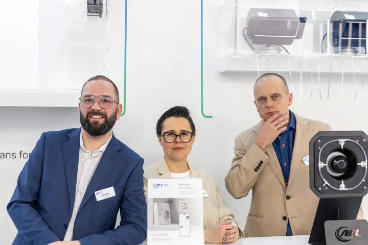 Close portrait of AFL Motors Europe staff at the counter at MCE 2026