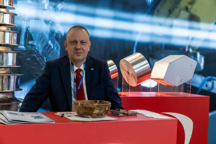 Close portrait at a red counter with foil rolls, repeat frame