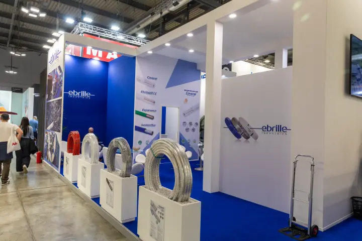 Coils of insulated pipe on white plinths along the Ebrille stand
