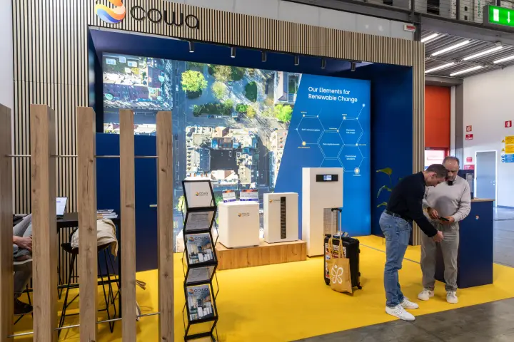Cowa stand with white compact units under the Renewable Change backdrop at MCE 2026