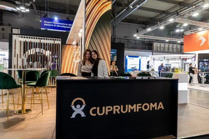 Cuprumfoma reception counter with gold logo and staff behind it