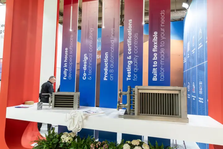 DBM finned coils in front of banners on software, testing and production at MCE 2026
