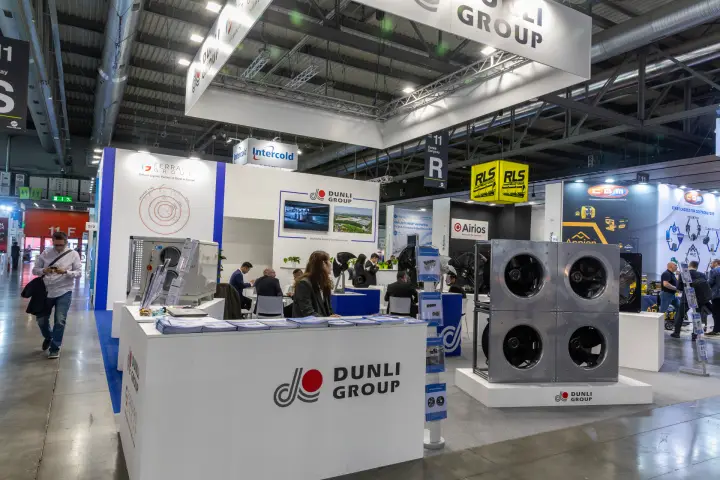 Dunli Group stand with a four-fan plug fan wall and reception counter at MCE 2026