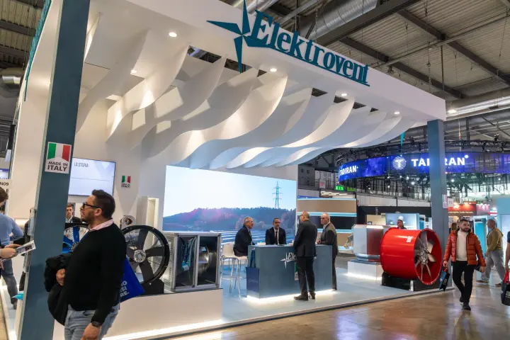 Elektrovent fascia logo above wave ceiling, fans and meeting counter