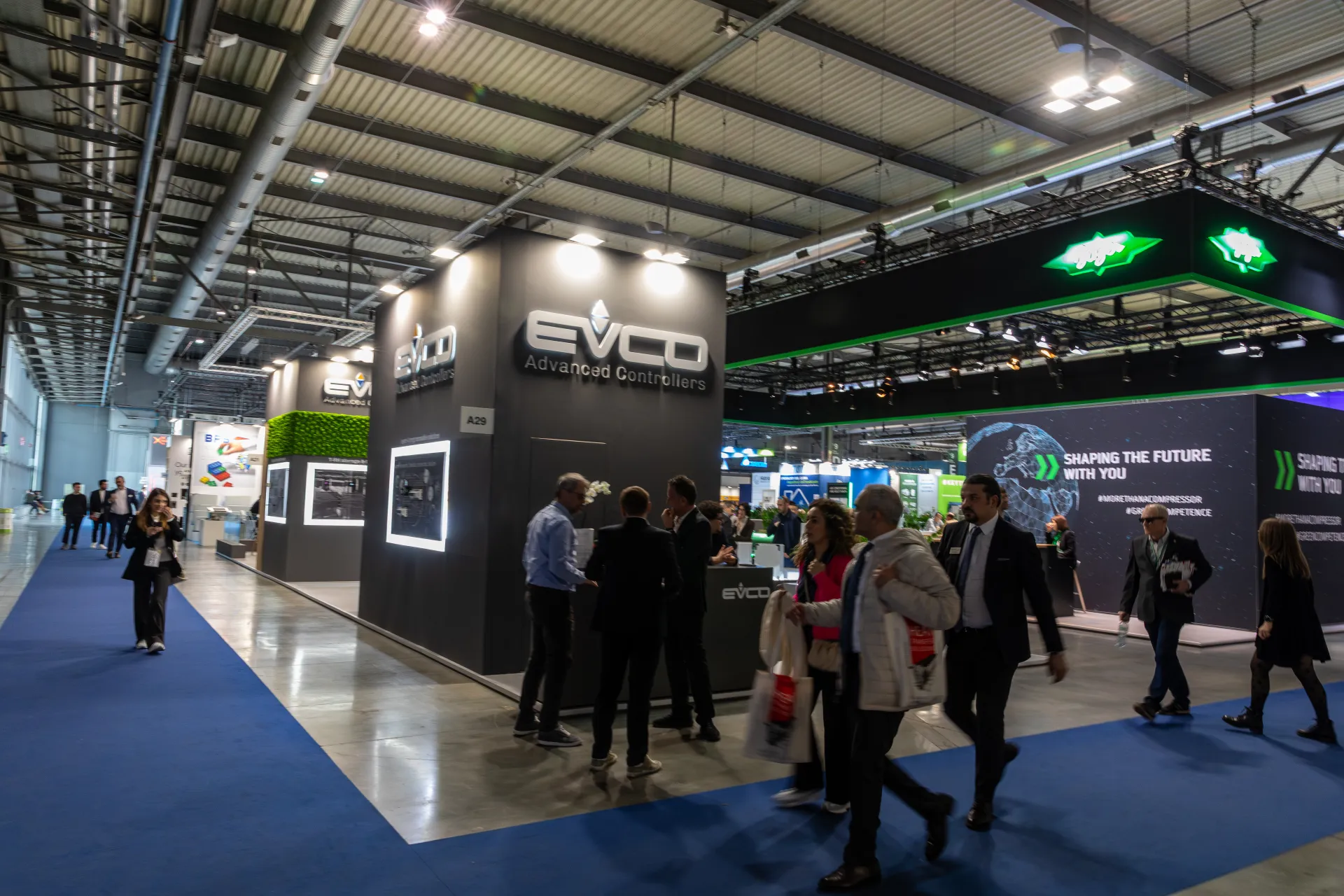 EVCO Advanced Controllers stand beside a blue-carpeted aisle at MCE 2026