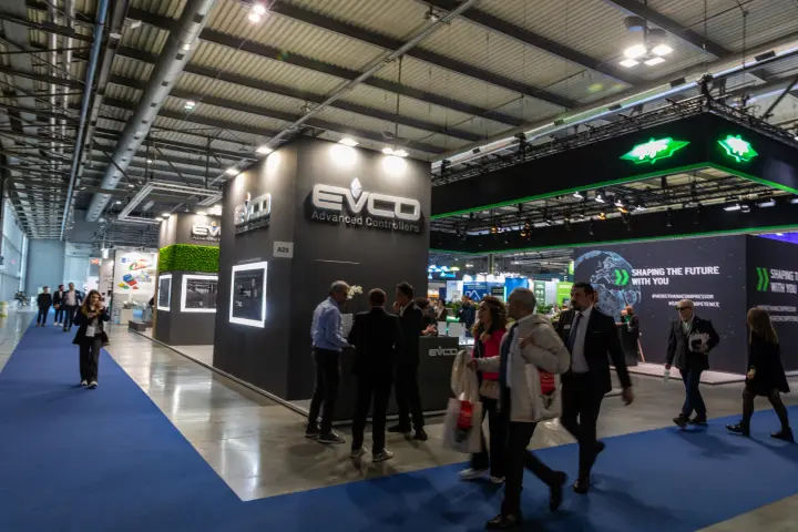 EVCO Advanced Controllers stand beside a blue-carpeted aisle at MCE 2026