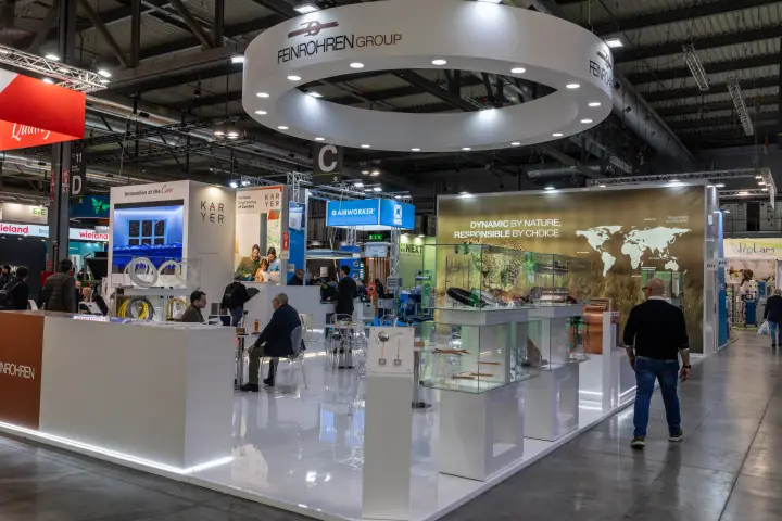 Feinrohren Group stand with suspended ring sign and copper tube showcases