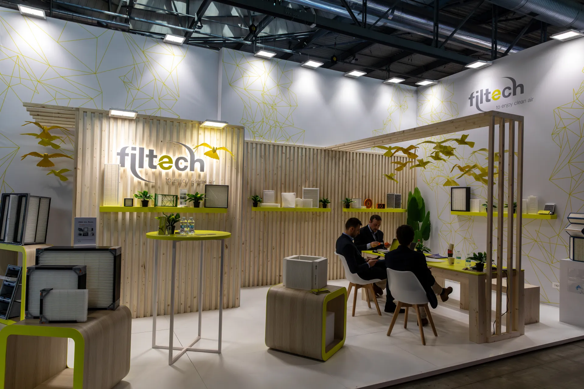 Filtech stand with framed air filters and a meeting table under a timber pergola at MCE 2026