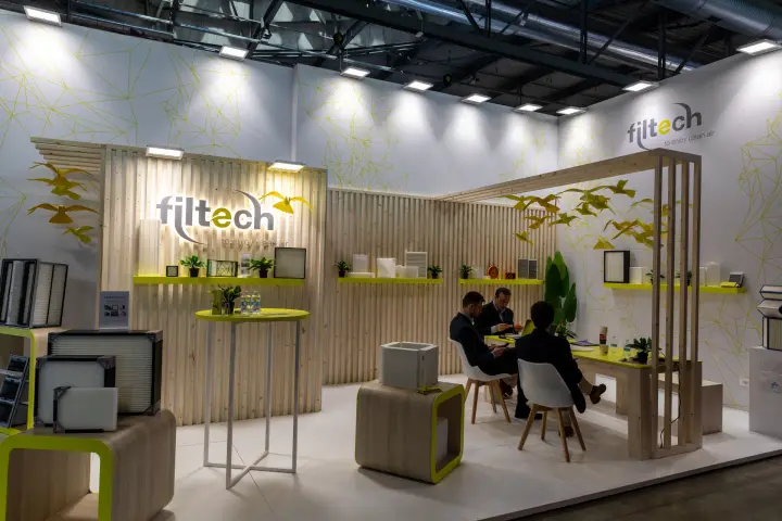 Filtech stand with framed air filters and a meeting table under a timber pergola at MCE 2026