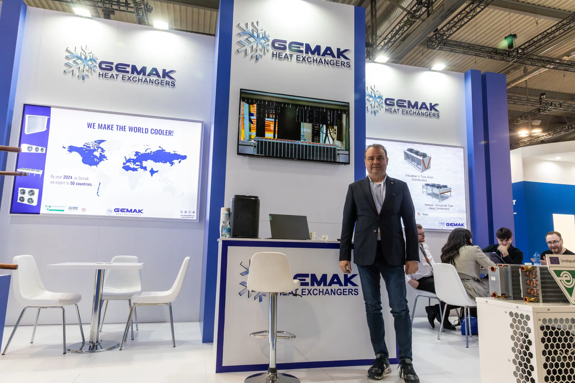 Gemak Heat Exchangers logos above reception counter and screen at MCE 2026