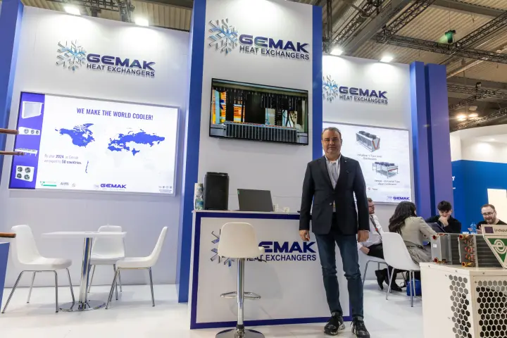 Gemak Heat Exchangers logos above reception counter and screen at MCE 2026