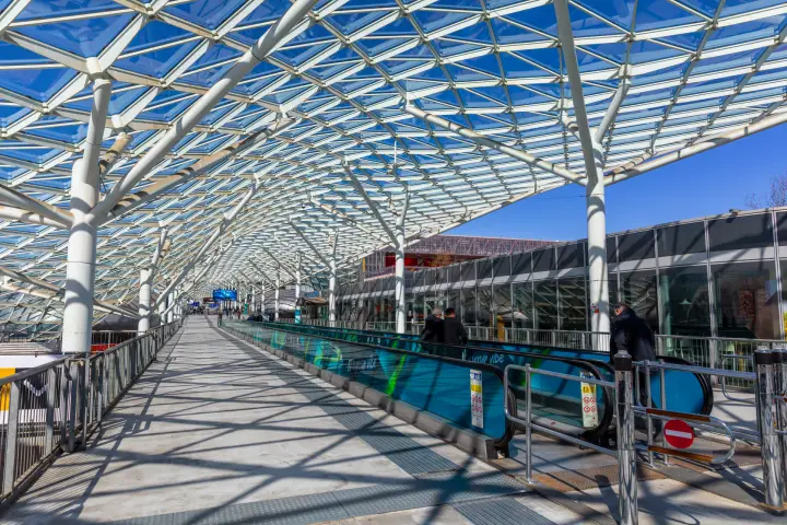 Glass and steel canopy arching over the fairground's central walkway at MCE 2026