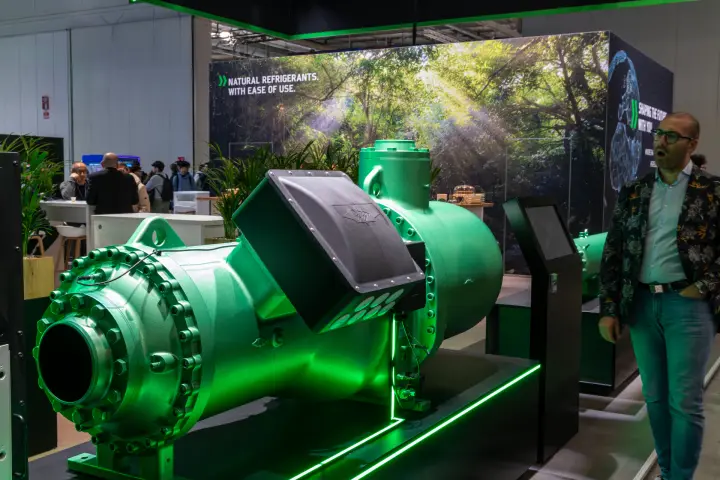 Green Bitzer compressor before a forest backdrop reading 'Natural refrigerants' at MCE 2026
