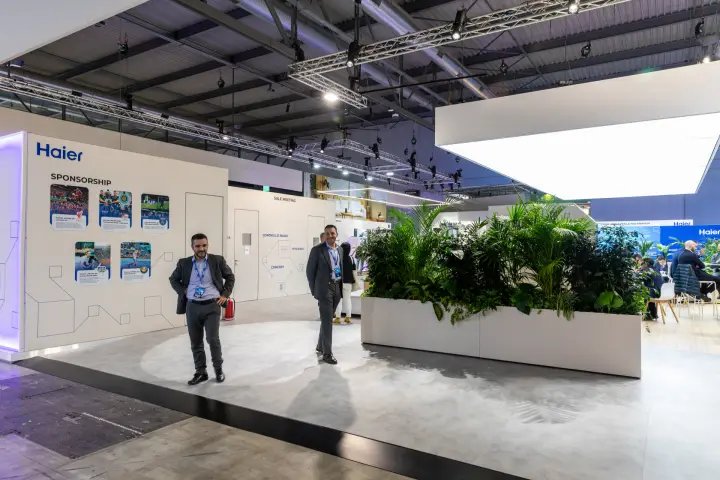 Haier stand with sponsorship wall, meeting rooms and planter divider at MCE 2026