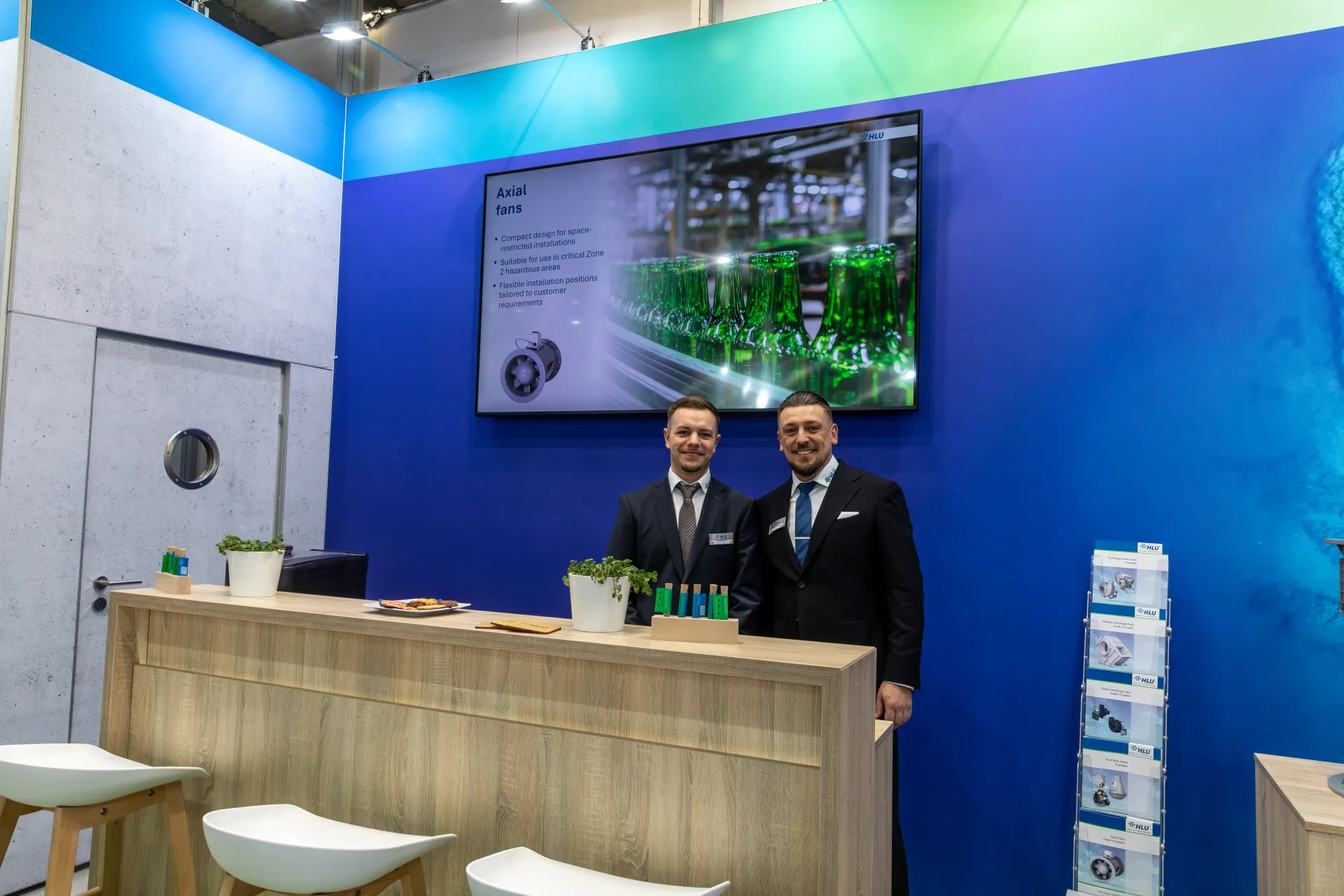 HLU reception counter under an "Axial fans" presentation screen at MCE 2026