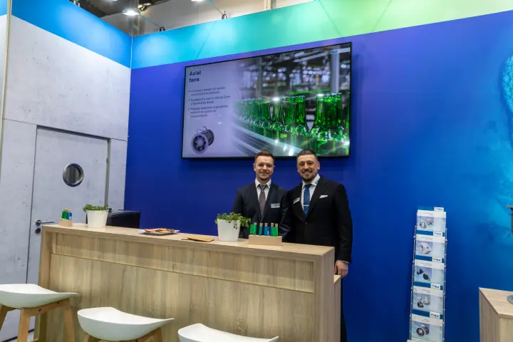 HLU reception counter under an "Axial fans" presentation screen at MCE 2026