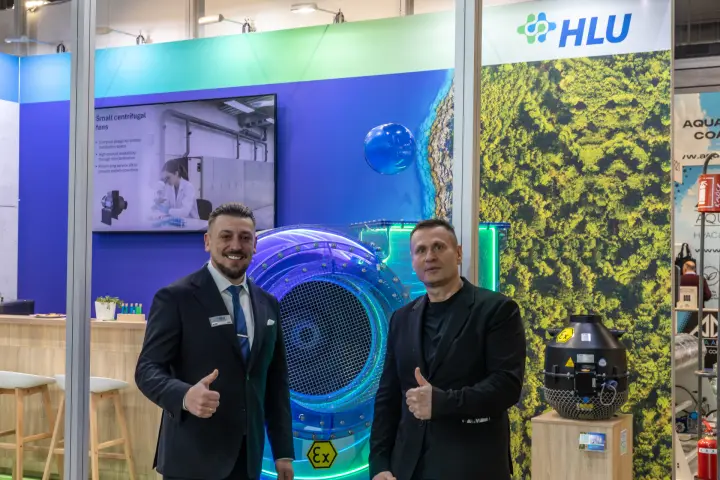 HLU staff beside a transparent ATEX fan and a black Ex-marked fan at MCE 2026