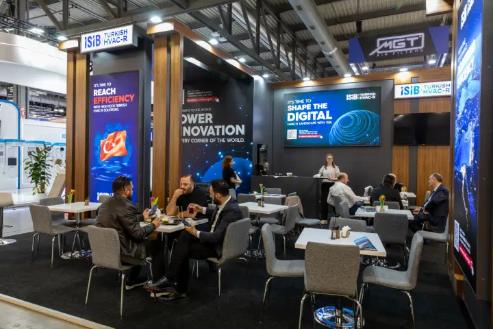 ISIB Turkish HVAC-R lounge with cafe tables and digital screens