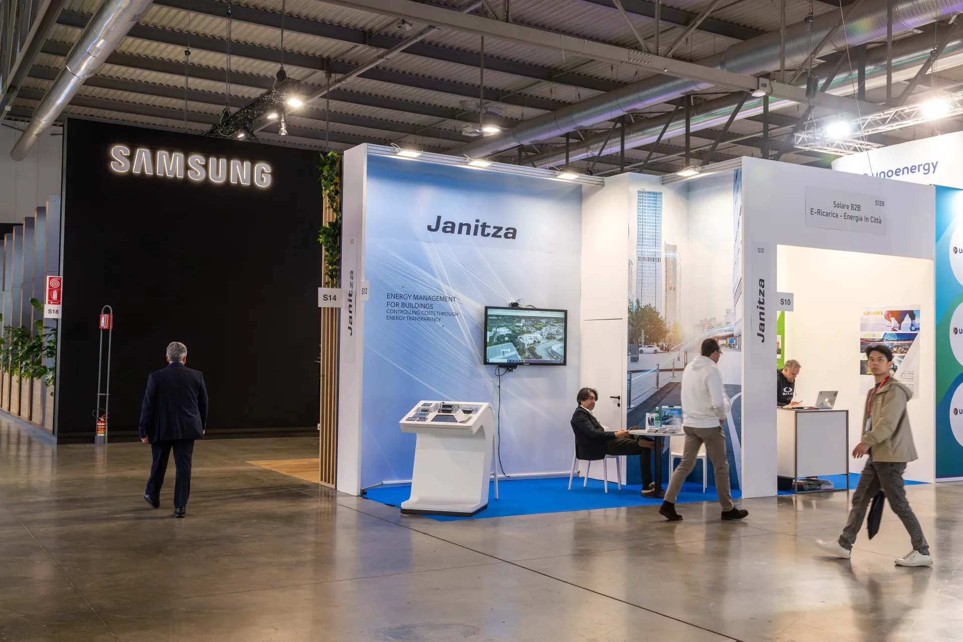 Janitza energy management stand with blue carpet and video screen at MCE 2026