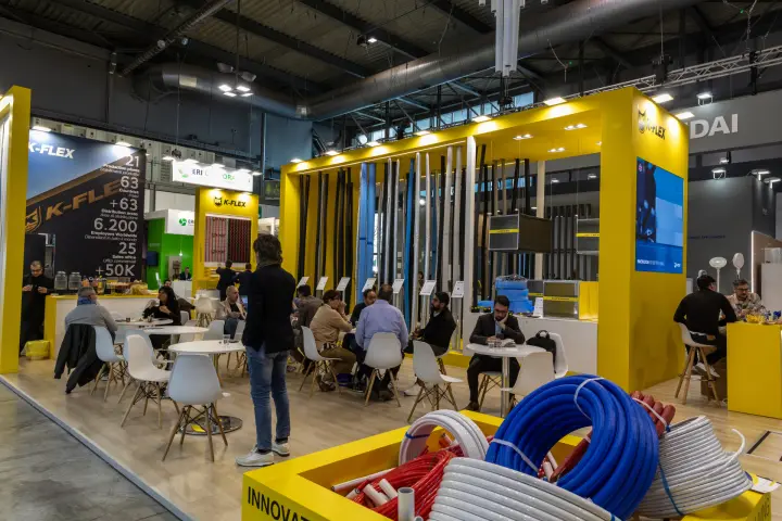 K-Flex yellow stand with busy café area and insulated pipe samples at MCE 2026