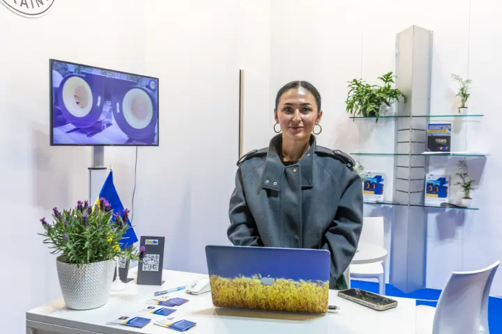 KVZO booth counter with laptop and brochure shelves at MCE 2026