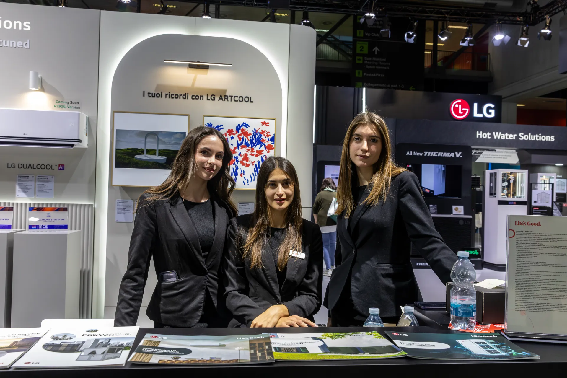 LG staff at the brochure counter with ARTCOOL and DUALCOOL AI displays at MCE 2026