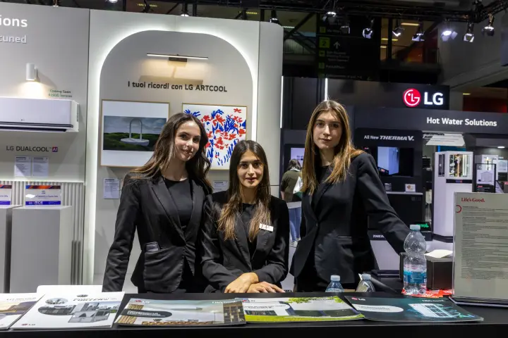 LG staff at the brochure counter with ARTCOOL and DUALCOOL AI displays at MCE 2026