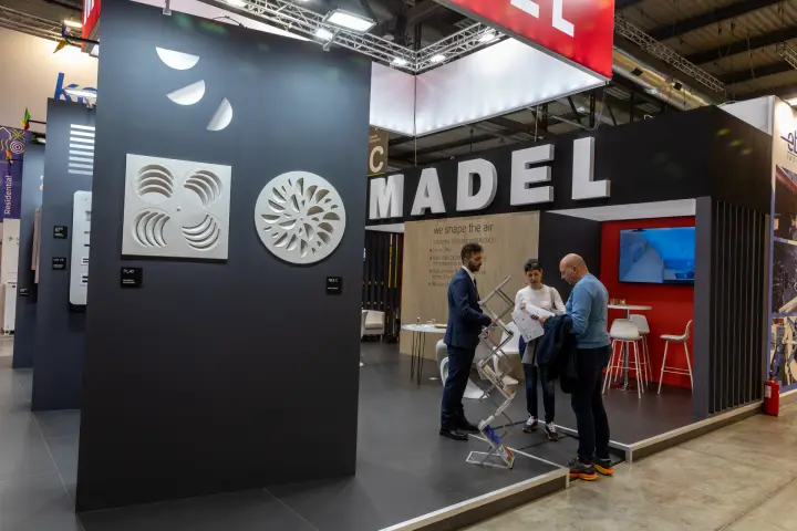Madel stand with PLAY and NEX C diffusers on a dark display wall at MCE 2026
