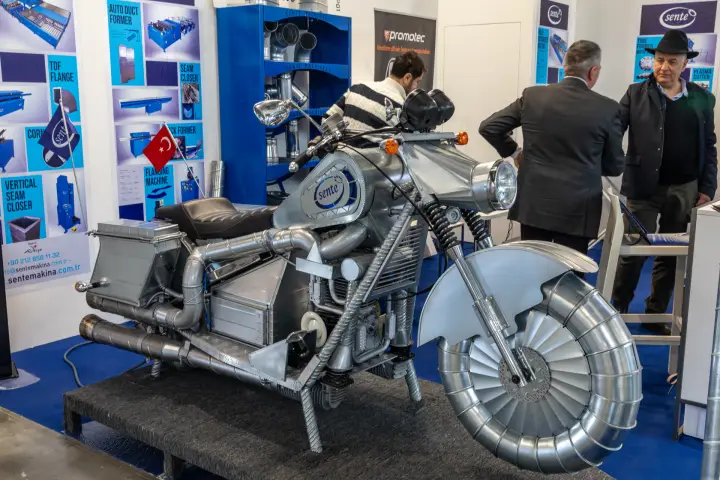 Motorcycle sculpture built from spiral ducts and fittings at the Sente stand at MCE 2026