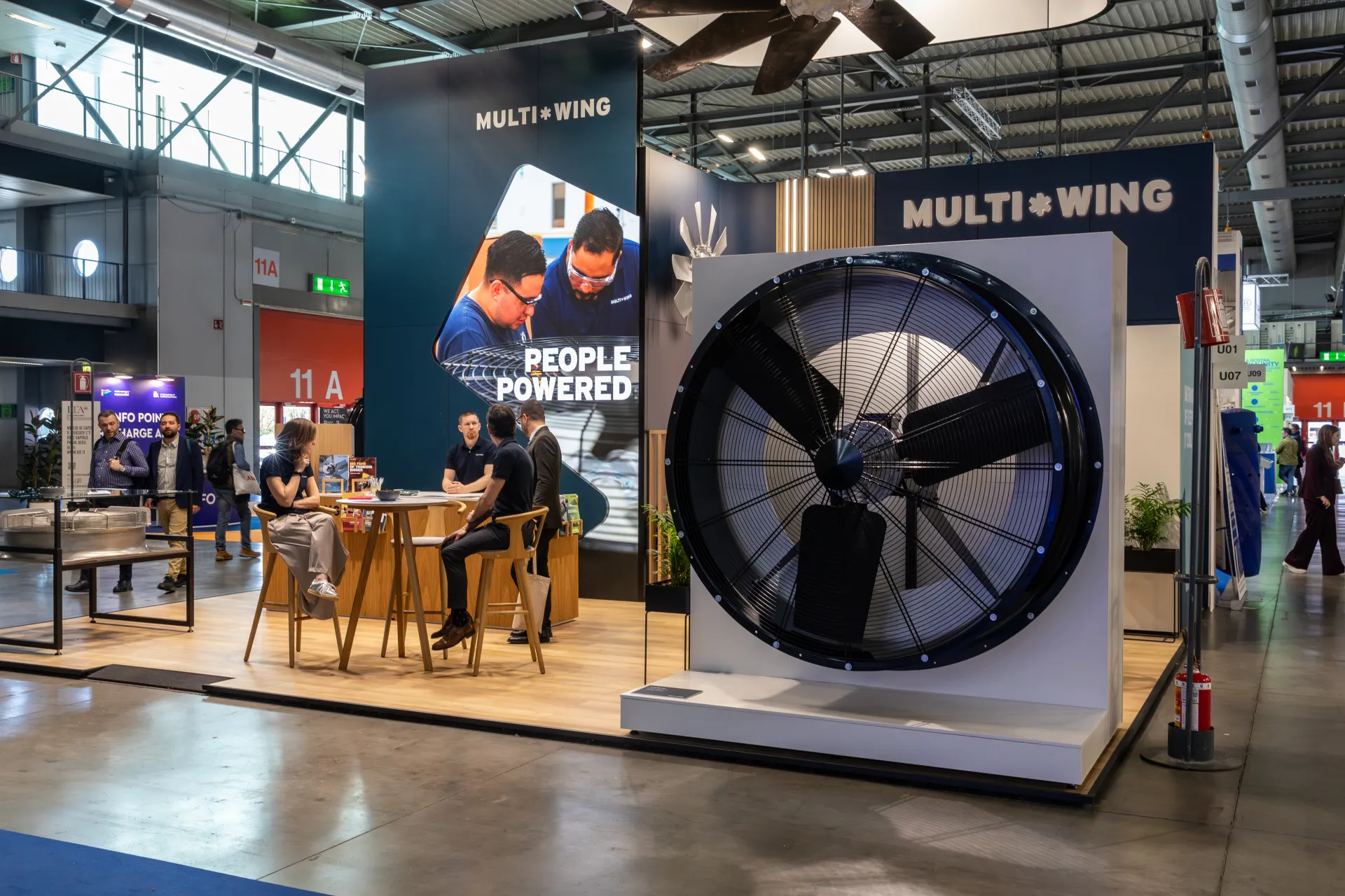 Multi-Wing large axial fan display beside 'People Powered' screen at MCE 2026