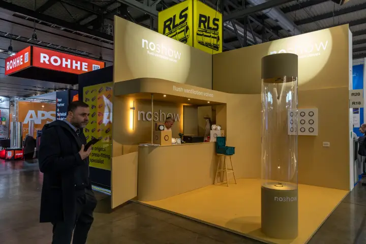 Noshow stand with acrylic valve column and curved ochre counter at MCE 2026