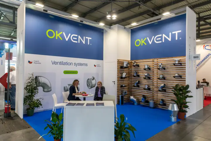 Okvent stand with galvanised duct fittings on a slatted wooden wall