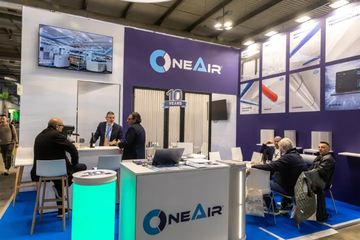 OneAir stand marking 10 years, with textile duct and diffuser product panels at MCE 2026