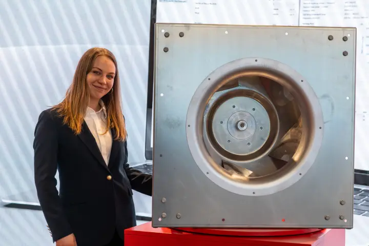 Plug fan with square steel inlet plate on a red plinth, inlet side at MCE 2026