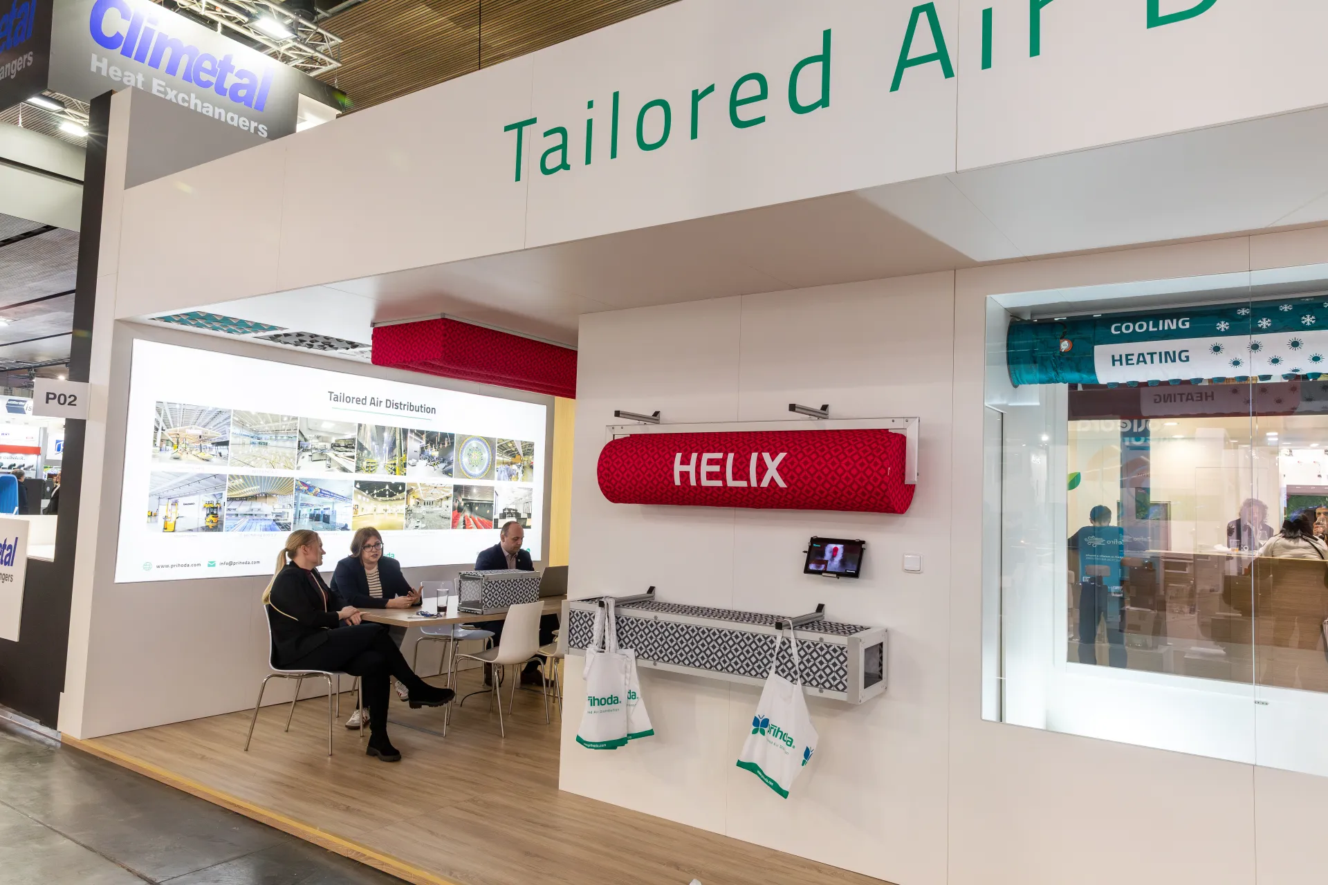 Příhoda stand with red Helix fabric duct and Tailored Air Distribution wall at MCE 2026