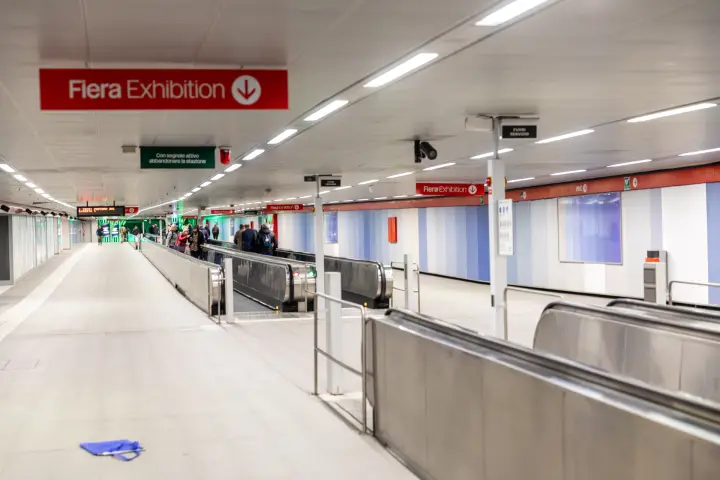 Red 'Fiera Exhibition' signs above the metro passage to the fairground at MCE 2026