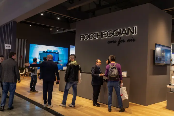Roccheggiani stand with backlit 'care for air' logo and R290 chiller video wall at MCE 2026