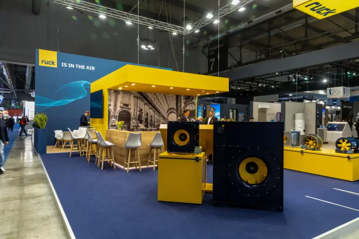 Ruck stand with centrifugal fans and a yellow-canopied wooden bar