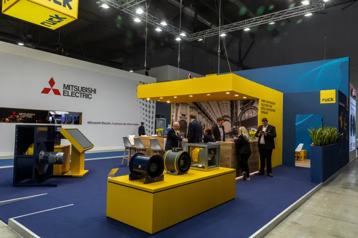 Ruck stand with inline duct fans and a box fan on a yellow podium at MCE 2026