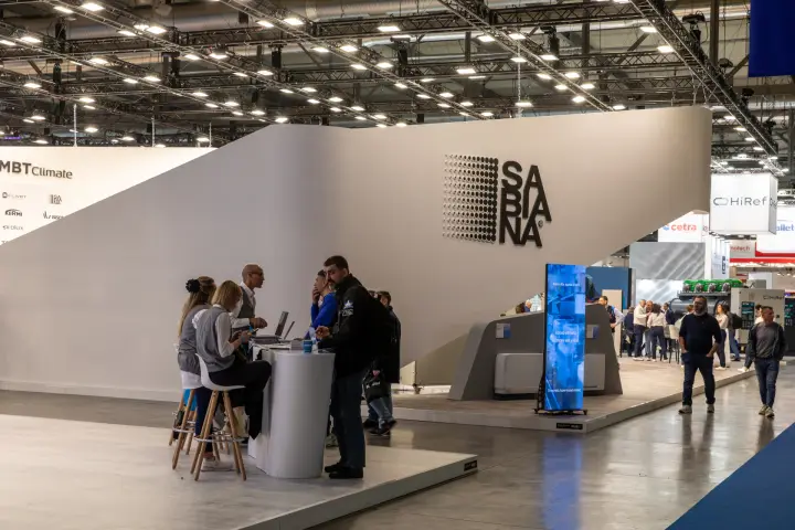 Sabiana stand with dotted logo wall and round reception counter