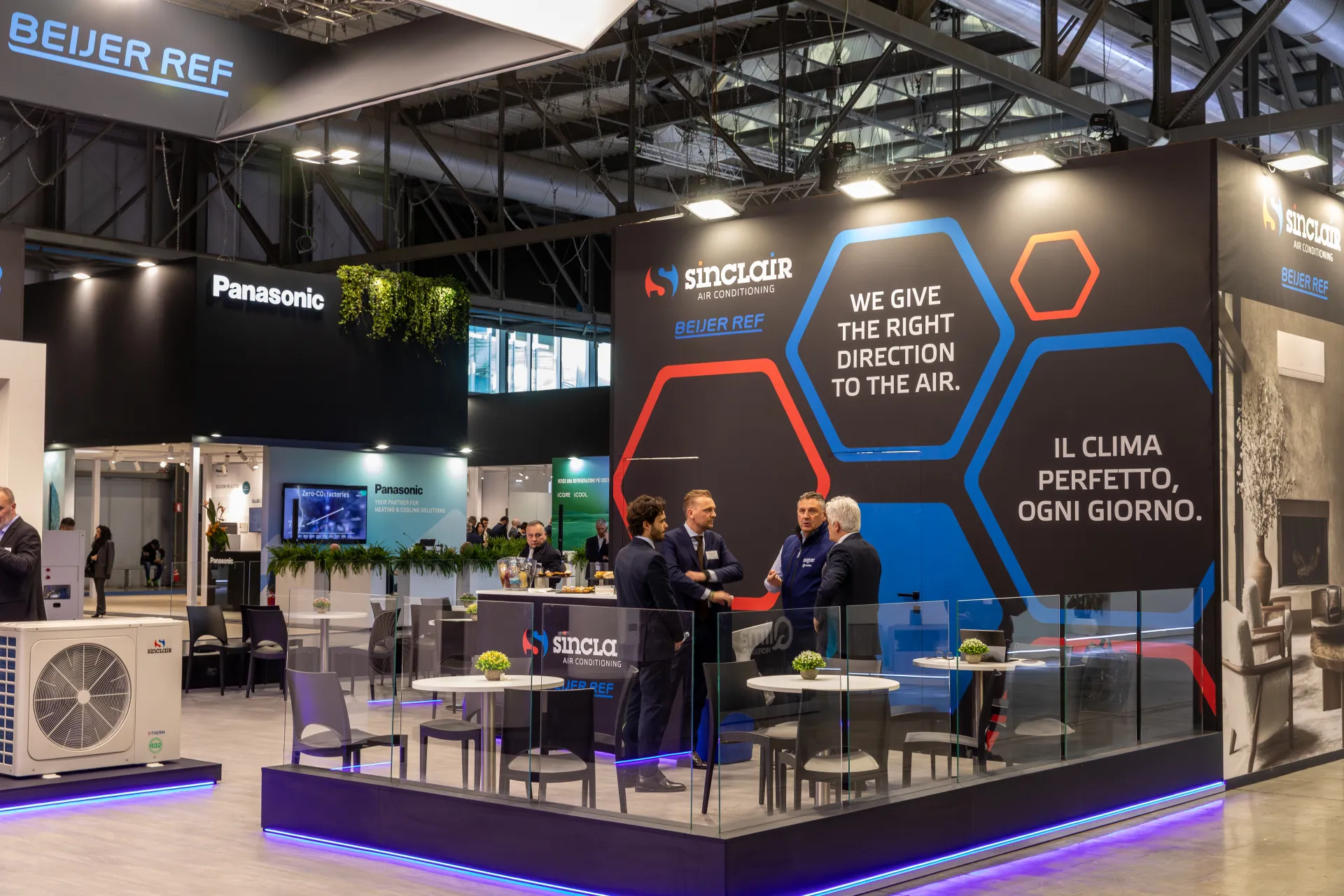 Sinclair glass-walled lounge with hexagon graphics and Italian slogan at MCE 2026