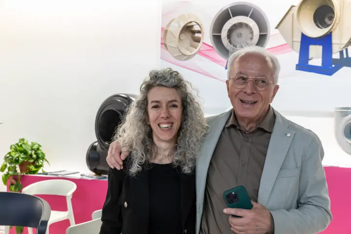 Smiling pair posed before an industrial fan display at MCE 2026