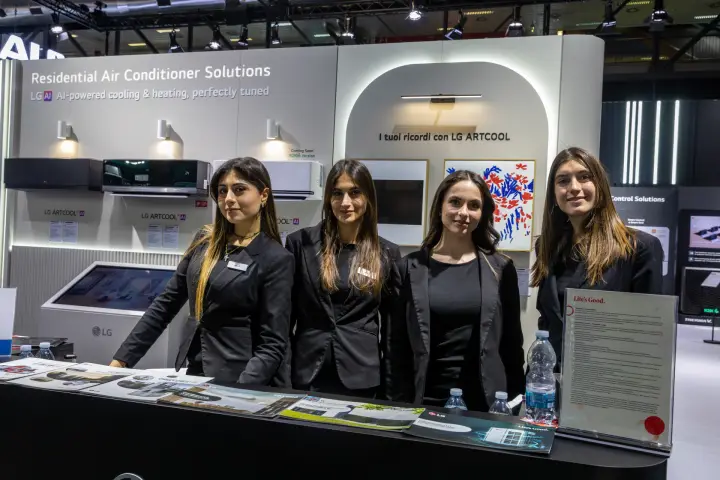 Staff at the LG counter in front of the Artcool wall-mounted air conditioners at MCE 2026