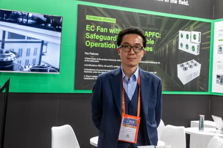 Staff portrait before an EC fan with built-in APFC panel