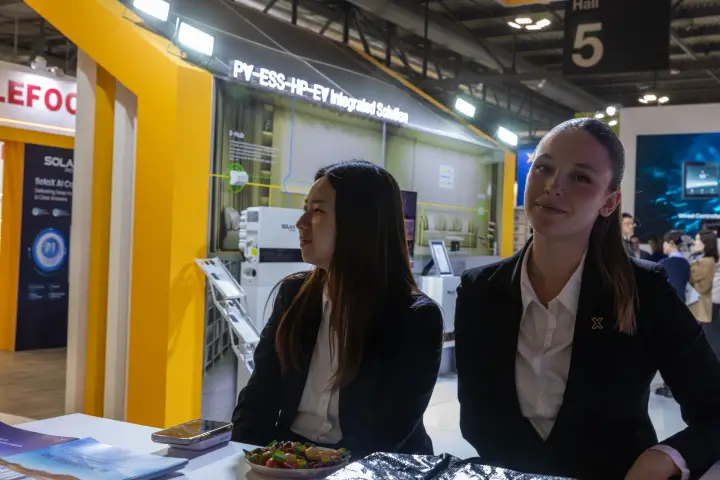 Staff at the SolaX Power reception counter with brochures