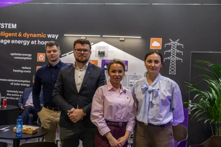 Stand team in front of a home energy management wall graphic