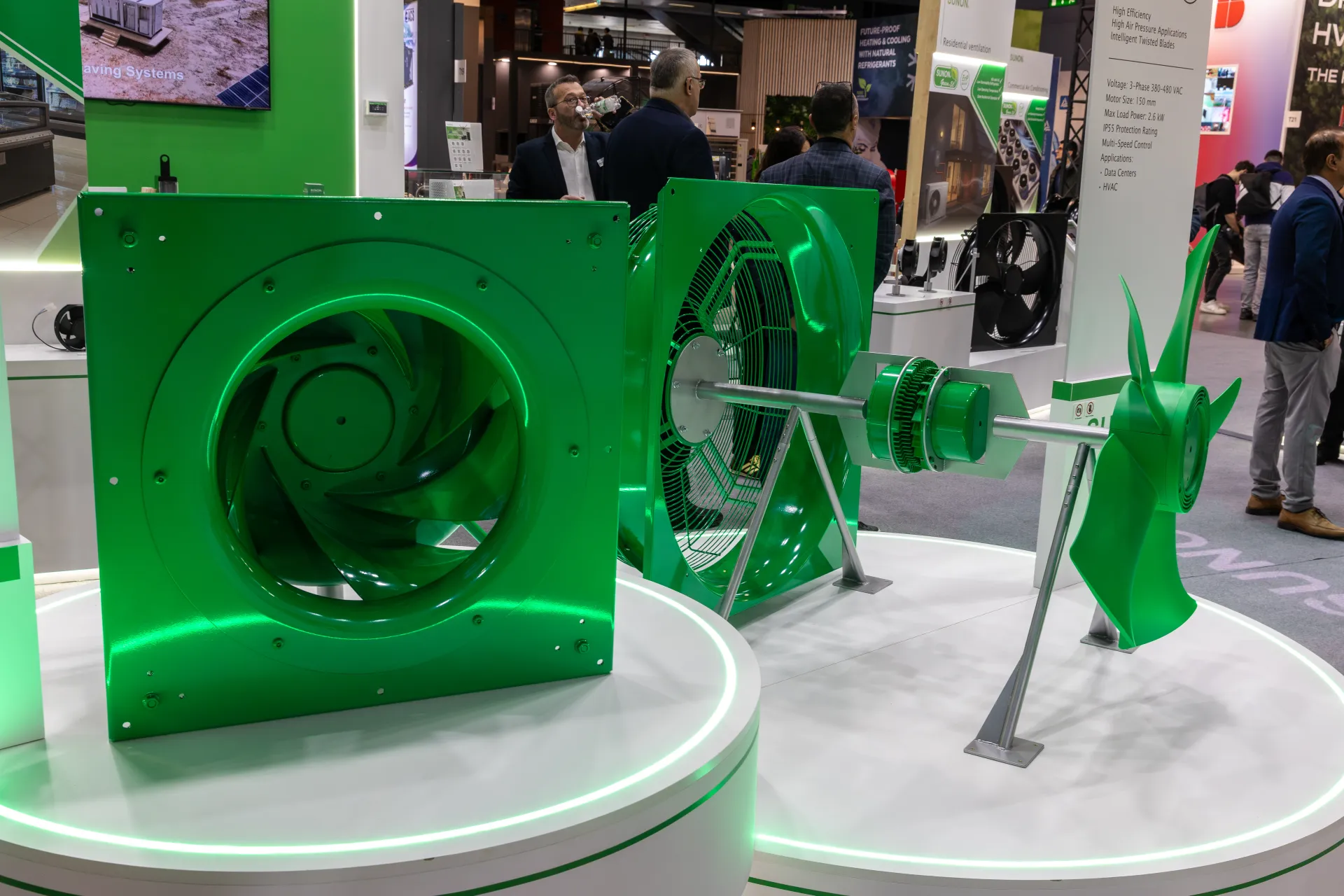 Sunon green plug fan and exploded axial fan assembly on lit plinths at MCE 2026